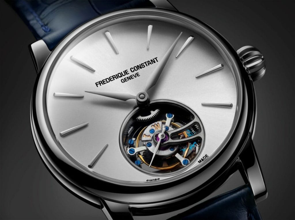 Cadran argenté avec finition ensoleillée; index appliqués facettés au diamant; aiguilles des heures et des minutes argentées et polies à la main; ouverture Heart Beat à 6 heures avec tourbillon 60 secondes; aiguille des secondes argentée.